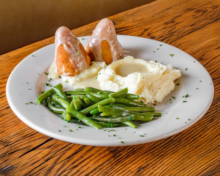 Our famous chicken croquettes with gravy, mashed potatoes and green beans