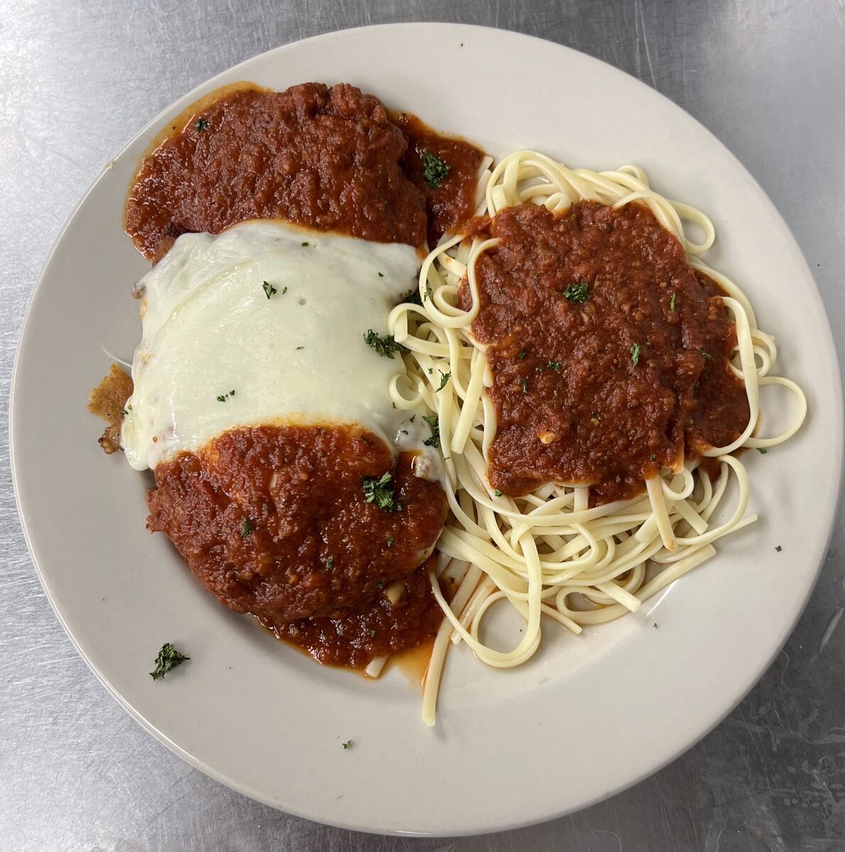 Chicken Parmesan over spaghetti