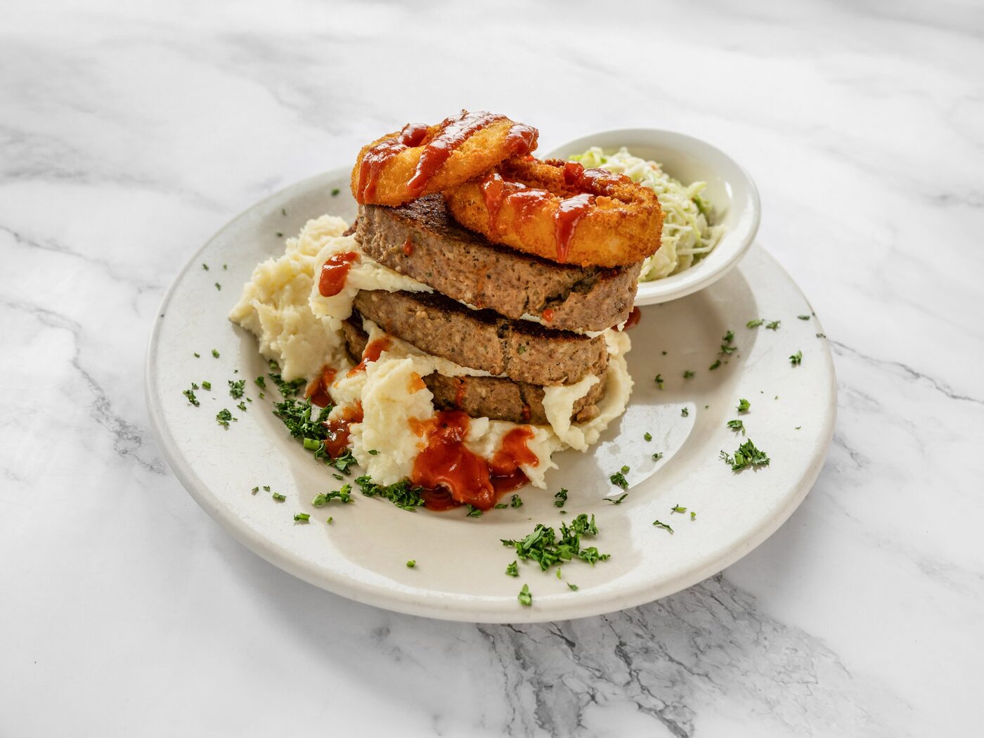 Mile-high meatloaf with mashed potatoes and onion rings