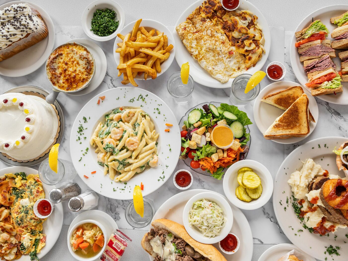 A spread of Dining Car favorites — pasta, salads, sandwiches, soups and cakes